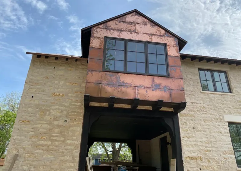 Copper metal panel facade on a stone building for Skylight Installation in Crooked River Ranch