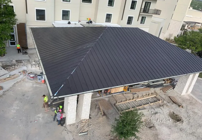 Metal roofing installation team working on a commercial building in Crooked River Ranch
